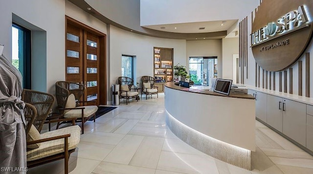 reception area with a towering ceiling and recessed lighting