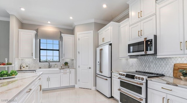 kitchen featuring high quality appliances, white cabinets, a sink, light stone countertops, and crown molding