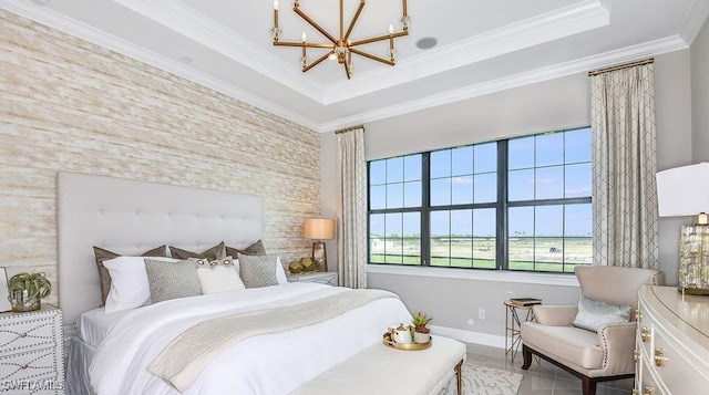 bedroom featuring a chandelier, a tray ceiling, crown molding, and baseboards