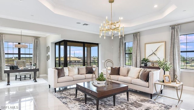 living room with an office area, baseboards, a chandelier, a tray ceiling, and crown molding