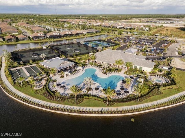 view of property location featuring a pool and a nearby body of water