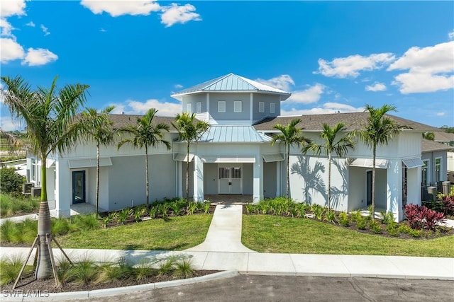 16515 Fire Coral Ln, North Fort Myers, FL 33903 - view of front of property with stucco siding, a front lawn, metal roof, and a standing seam roof
