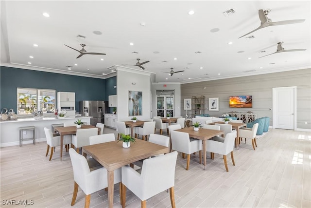 16515 Fire Coral Ln, North Fort Myers, FL 33903 - dining room with a ceiling fan, ornamental molding, recessed lighting, light wood-style floors, and baseboards
