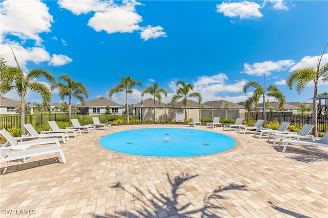 16515 Fire Coral Ln, North Fort Myers, FL 33903 - view of swimming pool featuring a patio and a residential view
