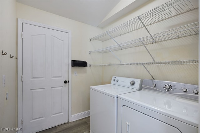 8970 Woodgate Manor Ct, Fort Myers, FL 33908 - washroom featuring washer and dryer, baseboards, and dark wood-style floors