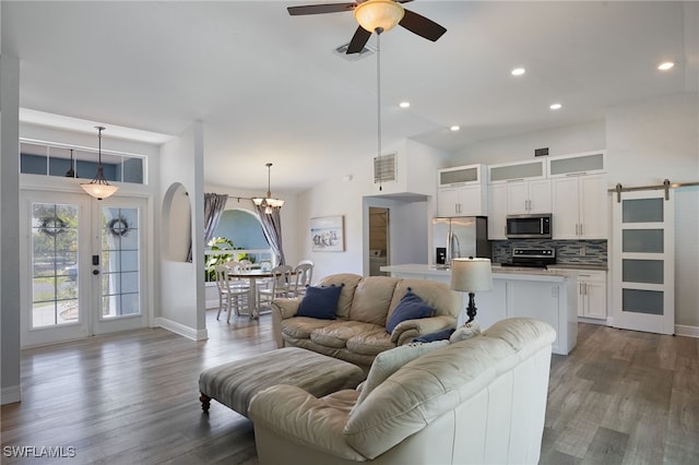 8970 Woodgate Manor Ct, Fort Myers, FL 33908 - living room with healthy amount of natural light, a ceiling fan, a barn door, dark wood finished floors, and recessed lighting