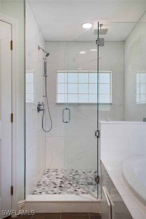 8970 Woodgate Manor Ct, Fort Myers, FL 33908 - bathroom featuring plenty of natural light, a stall shower, and a bath