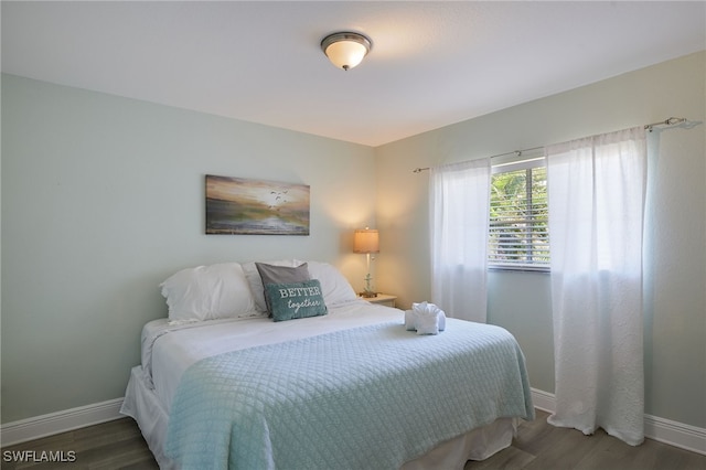 8970 Woodgate Manor Ct, Fort Myers, FL 33908 - bedroom featuring baseboards and wood finished floors