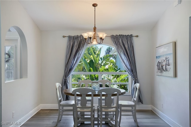 8970 Woodgate Manor Ct, Fort Myers, FL 33908 - dining area with a chandelier, healthy amount of natural light, arched walkways, and baseboards