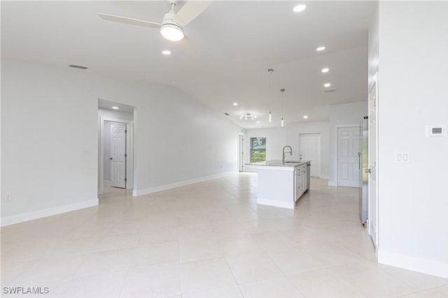 unfurnished living room with a sink, recessed lighting, a ceiling fan, baseboards, and lofted ceiling
