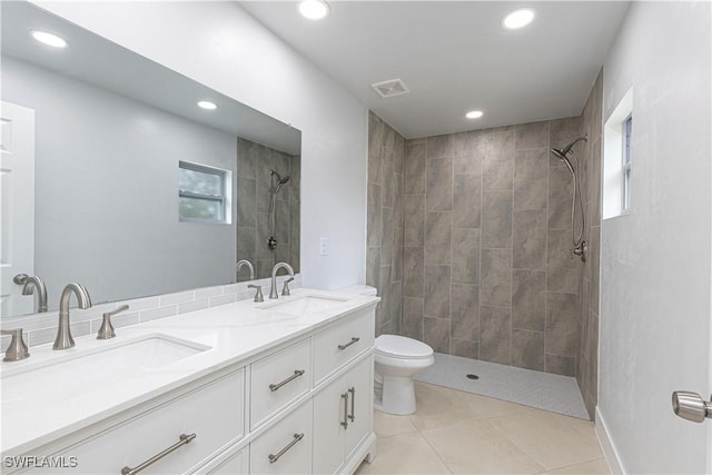 bathroom featuring recessed lighting, a tile shower, tile patterned flooring, toilet, and double vanity
