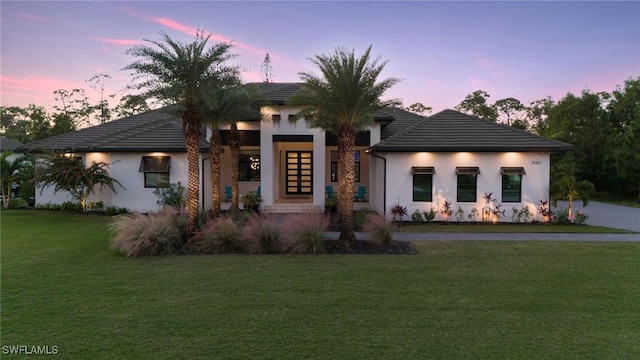 15392 Old Pine Ct, Fort Myers, FL 33912 - view of front facade featuring a lawn, french doors, stucco siding, and a tile roof