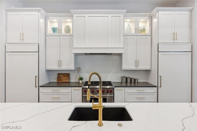 15392 Old Pine Ct, Fort Myers, FL 33912 - kitchen with high end appliances, wall chimney exhaust hood, and white cabinets