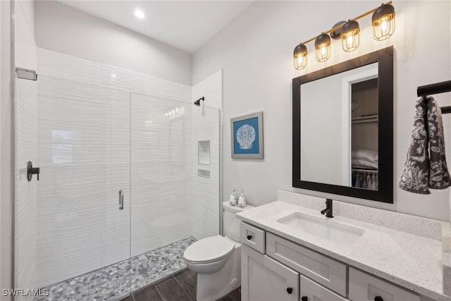 15392 Old Pine Ct, Fort Myers, FL 33912 - full bathroom with vanity, a stall shower, toilet, wood finished floors, and recessed lighting