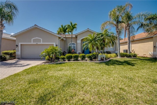 16112 Cutters Ct, Fort Myers, FL 33908 - view of front facade with decorative driveway, stucco siding, a garage, and a front yard