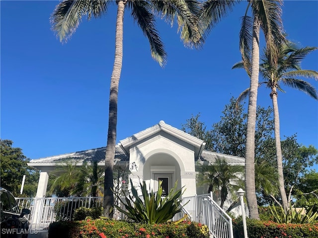 16112 Cutters Ct, Fort Myers, FL 33908 - view of side of home with a porch and stucco siding
