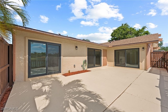 17307 Timber Oak Ln, Fort Myers, FL 33908 - rear view of house with stucco siding and a patio area