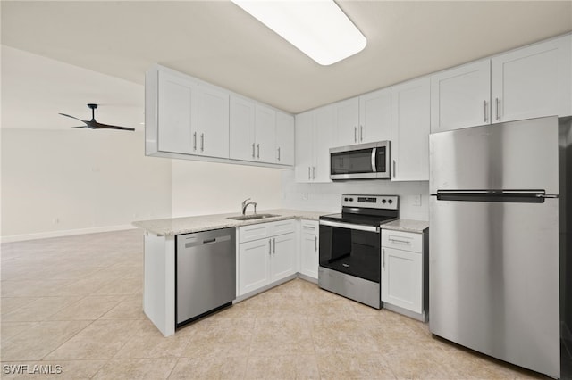 17307 Timber Oak Ln, Fort Myers, FL 33908 - kitchen with appliances with stainless steel finishes, white cabinets, a sink, and tasteful backsplash