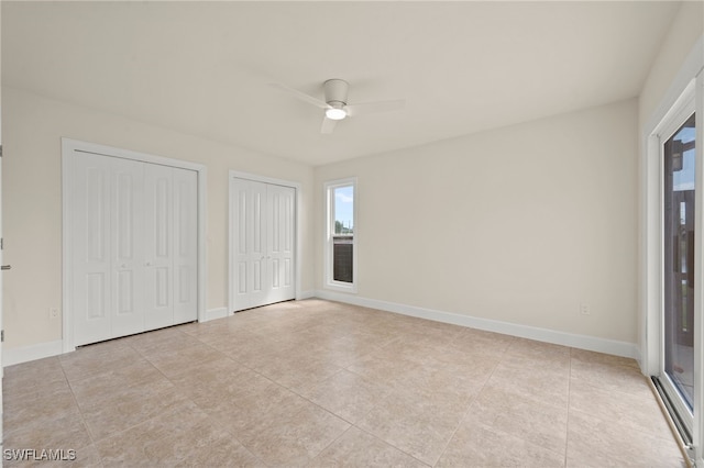 17307 Timber Oak Ln, Fort Myers, FL 33908 - unfurnished bedroom with multiple closets, light tile patterned flooring, multiple windows, and baseboards