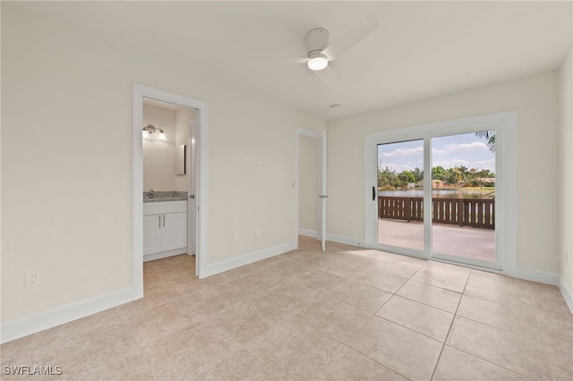 17307 Timber Oak Ln, Fort Myers, FL 33908 - unfurnished bedroom featuring access to exterior, light tile patterned flooring, baseboards, ensuite bath, and a sink