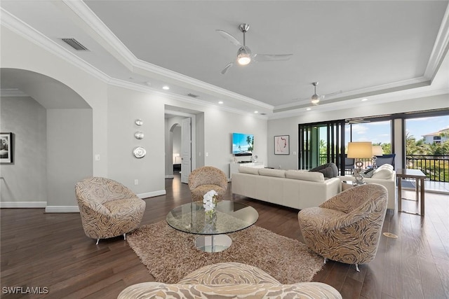 4750 Via Del Corso Ln Unit 201, Bonita Springs, FL 34134 - living area with a raised ceiling, arched walkways, wood finished floors, ceiling fan, and ornamental molding