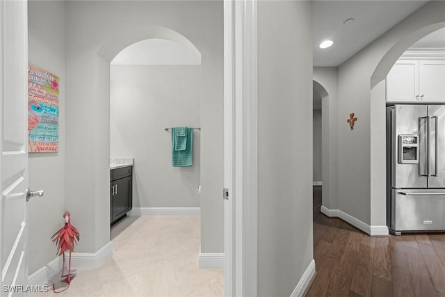4750 Via Del Corso Ln Unit 201, Bonita Springs, FL 34134 - corridor featuring arched walkways, baseboards, recessed lighting, and light wood-style floors