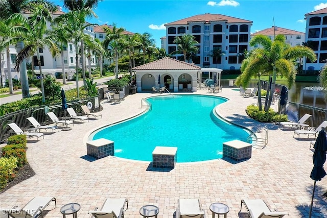 4750 Via Del Corso Ln Unit 201, Bonita Springs, FL 34134 - community pool with fence and a patio