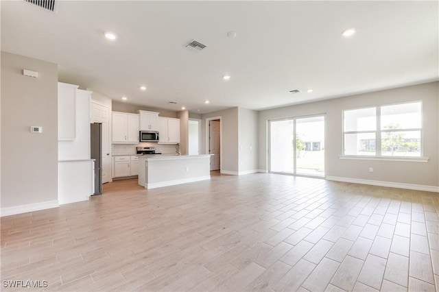 16811 Elkhorn Coral Dr, North Fort Myers, FL 33903 - unfurnished living room with recessed lighting and light wood finished floors