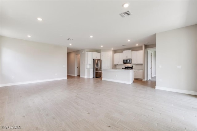 16811 Elkhorn Coral Dr, North Fort Myers, FL 33903 - unfurnished living room with recessed lighting and light wood-style floors