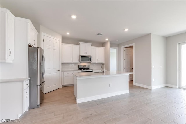 16811 Elkhorn Coral Dr, North Fort Myers, FL 33903 - kitchen featuring appliances with stainless steel finishes, backsplash, white cabinets, light countertops, and recessed lighting