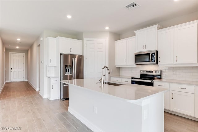 16811 Elkhorn Coral Dr, North Fort Myers, FL 33903 - kitchen with stainless steel appliances, tasteful backsplash, recessed lighting, light countertops, and an island with sink