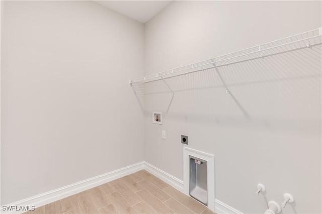 16811 Elkhorn Coral Dr, North Fort Myers, FL 33903 - laundry room with washer hookup, electric dryer hookup, gas dryer hookup, and light wood-style floors