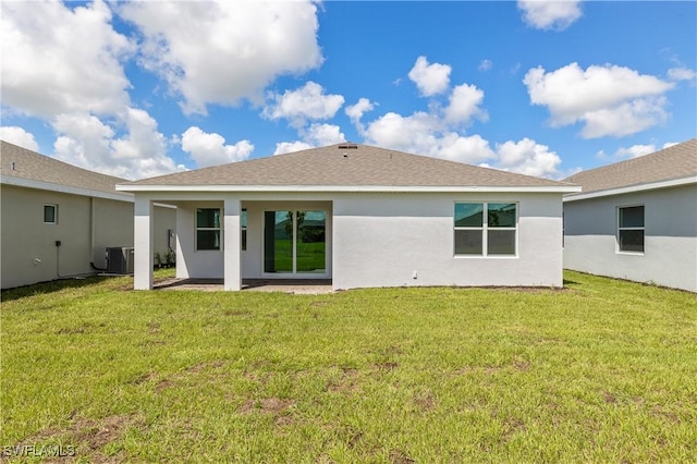 16811 Elkhorn Coral Dr, North Fort Myers, FL 33903 - back of house featuring a patio area, stucco siding, a yard, and roof with shingles