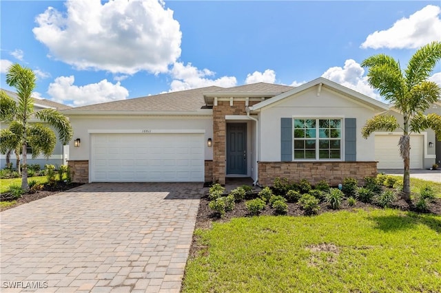 16811 Elkhorn Coral Dr, North Fort Myers, FL 33903 - view of front of property featuring stone siding, stucco siding, decorative driveway, and a garage