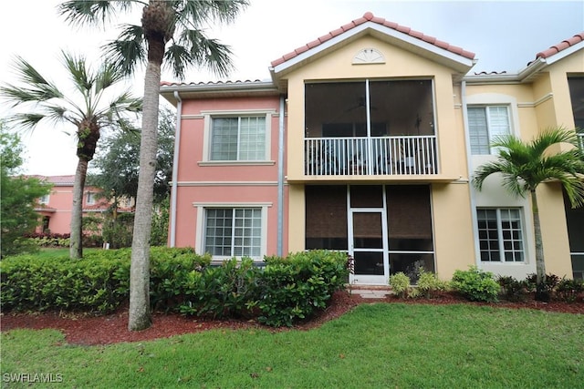 20321 Estero Gardens Cir Unit 108, Estero, FL 33928 - rear view of property featuring stucco siding, a balcony, a lawn, and a tile roof