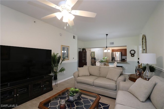 20321 Estero Gardens Cir Unit 108, Estero, FL 33928 - living room with a ceiling fan, baseboards, and light wood-style floors