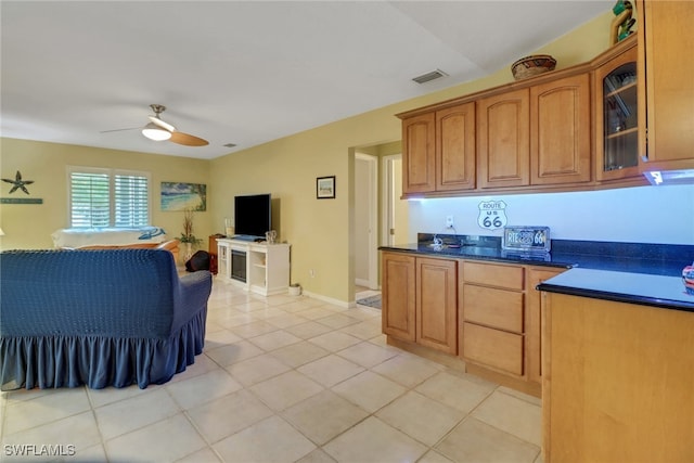 940 Golden Gate Blvd W, Naples, FL 34120 - kitchen with open floor plan, ceiling fan, dark countertops, light tile patterned floors, and glass insert cabinets