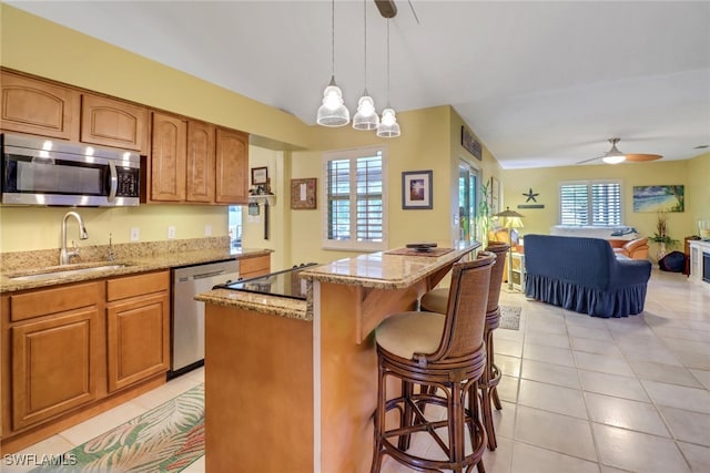 940 Golden Gate Blvd W, Naples, FL 34120 - kitchen featuring stainless steel appliances, a sink, a ceiling fan, and light stone countertops