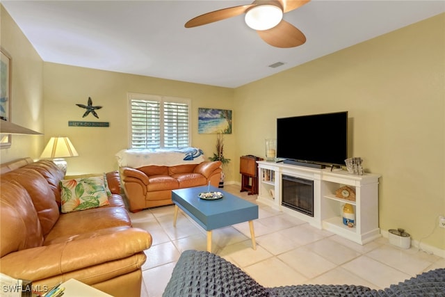 940 Golden Gate Blvd W, Naples, FL 34120 - living room with ceiling fan, light tile patterned floors, a glass covered fireplace, and baseboards