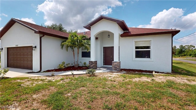 2505 4th St SW, Lehigh Acres, FL 33976 - view of front of property featuring stucco siding, an attached garage, a front lawn, and driveway