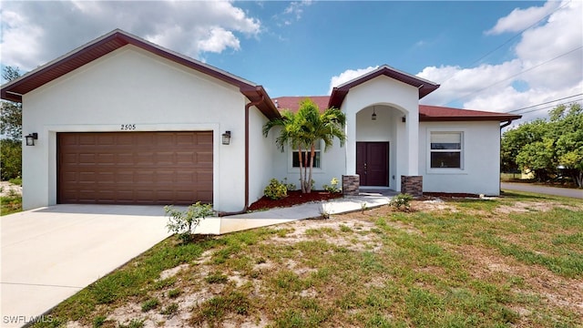 2505 4th St SW, Lehigh Acres, FL 33976 - view of front of house with stucco siding, a garage, and concrete driveway