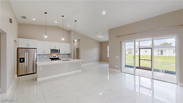 2505 4th St SW, Lehigh Acres, FL 33976 - kitchen with stainless steel appliances, a sink, decorative backsplash, high vaulted ceiling, and light countertops