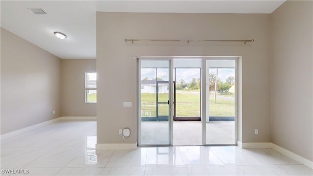 2505 4th St SW, Lehigh Acres, FL 33976 - doorway to outside featuring baseboards