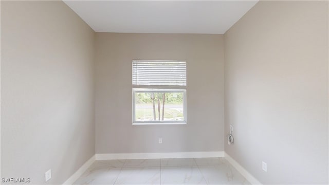 2505 4th St SW, Lehigh Acres, FL 33976 - empty room with light marble finish floors and baseboards