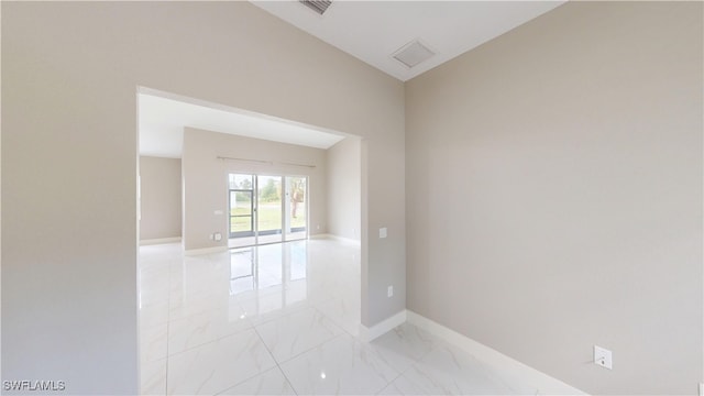 2505 4th St SW, Lehigh Acres, FL 33976 - unfurnished room featuring light marble finish floors and baseboards