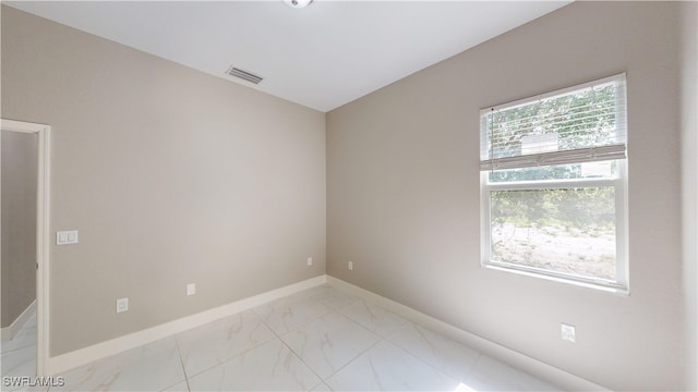 2505 4th St SW, Lehigh Acres, FL 33976 - unfurnished room featuring light marble finish flooring and baseboards