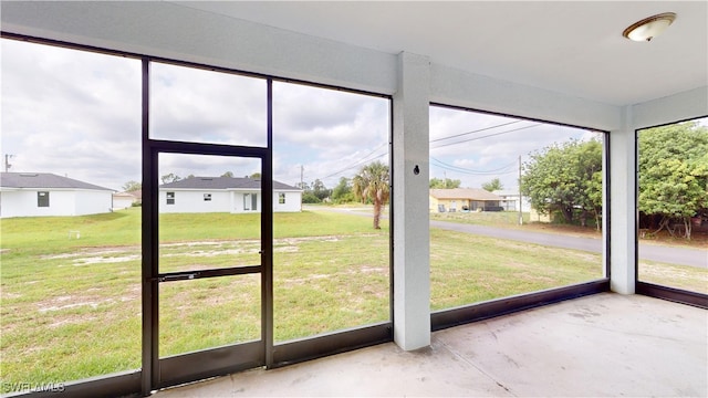 2505 4th St SW, Lehigh Acres, FL 33976 - unfurnished sunroom featuring a residential view