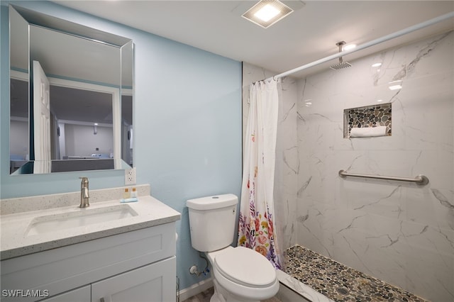 full bath featuring vanity, a shower stall, and toilet
