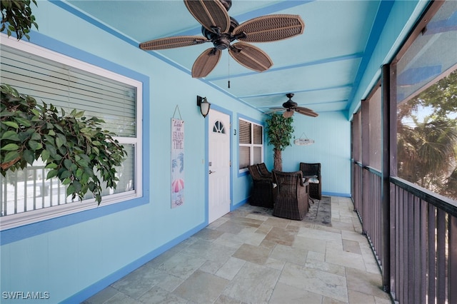sunroom / solarium featuring ceiling fan