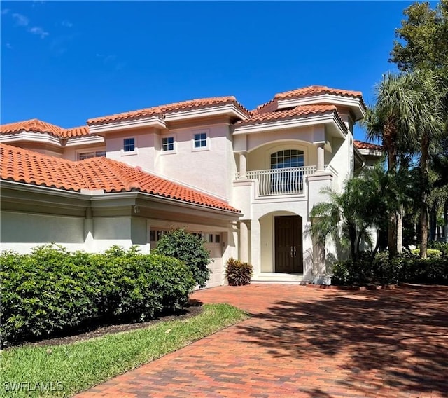 2452 Terra Verde Ln Unit 2452, Naples, FL 34105 - mediterranean / spanish-style house featuring a balcony, a tile roof, and stucco siding